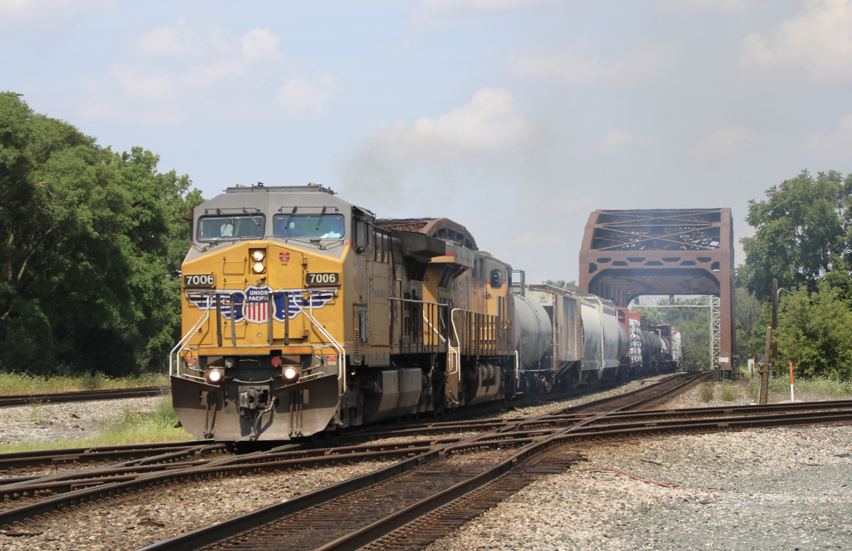 Freight train crossing diamond after crossing bridge