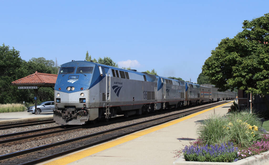 Passenger train passing commuter-train station