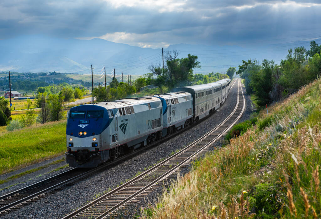 Passenger train under cloudy skies.