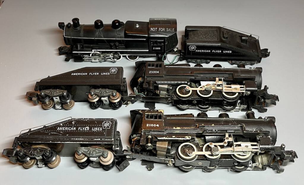 three vintage model trains with tenders