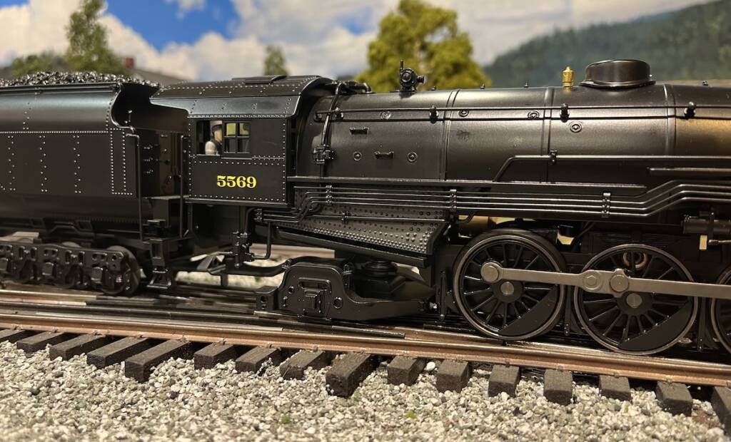 cab of black model steam locomotive