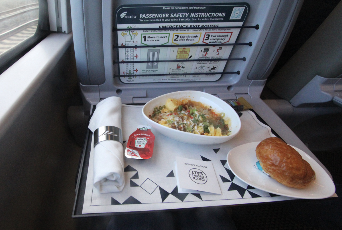 Food on seatback tray of passenger car