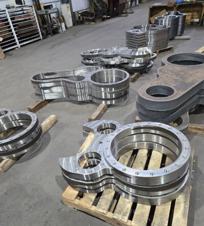 Metal steam locomotive parts on a factory floor. T1 No. 5550 cylinders nearing completion.