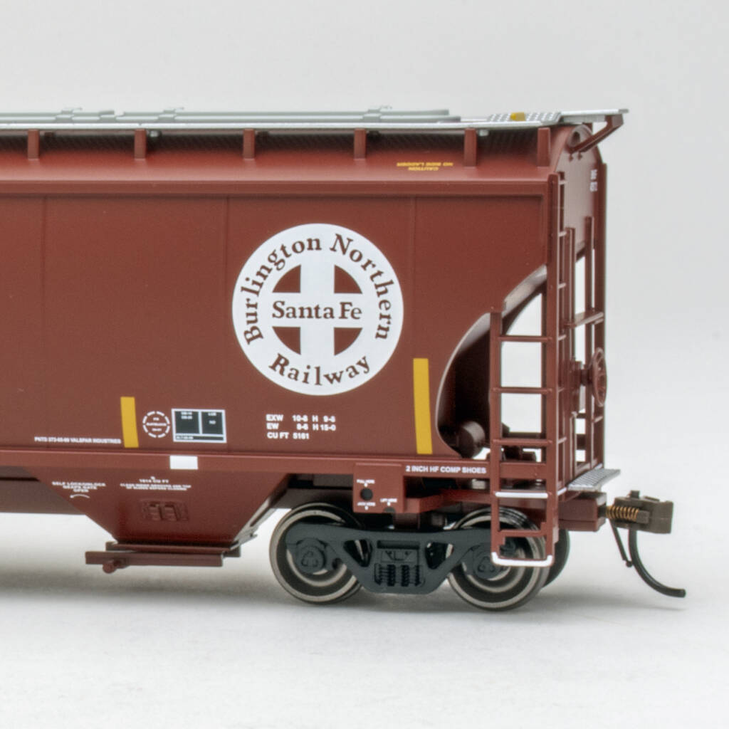 Color photo showing left side and B end of modern covered hopper painted mineral red with white, yellow, and black graphics on white background