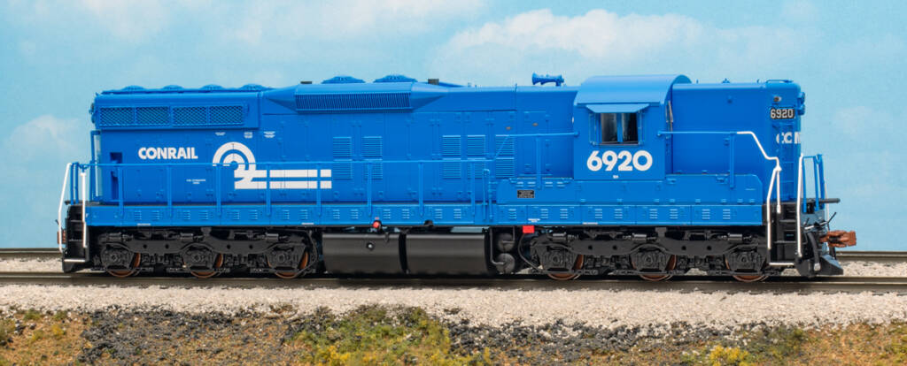 Color photo of HO scale six-axle EMD hood unit painted blue with white graphics on scenicked base with a sky blue background. 