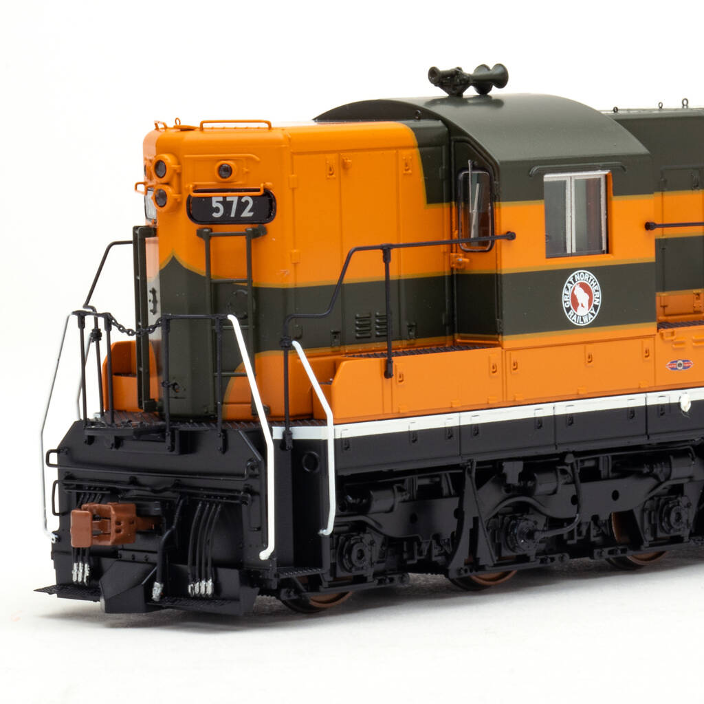 Color photo showing cab and short hood of HO scale six-axle EMD hood unit painted orange, green, and yellow with red, white, and black graphics on white background.