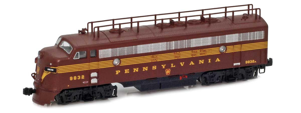 A maroon model locomotive with yellow lettering and stripes