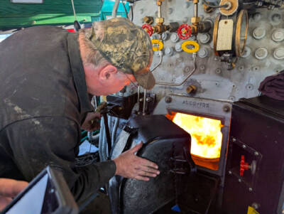 Drafting a fire in the firebox of a steam locomotive.