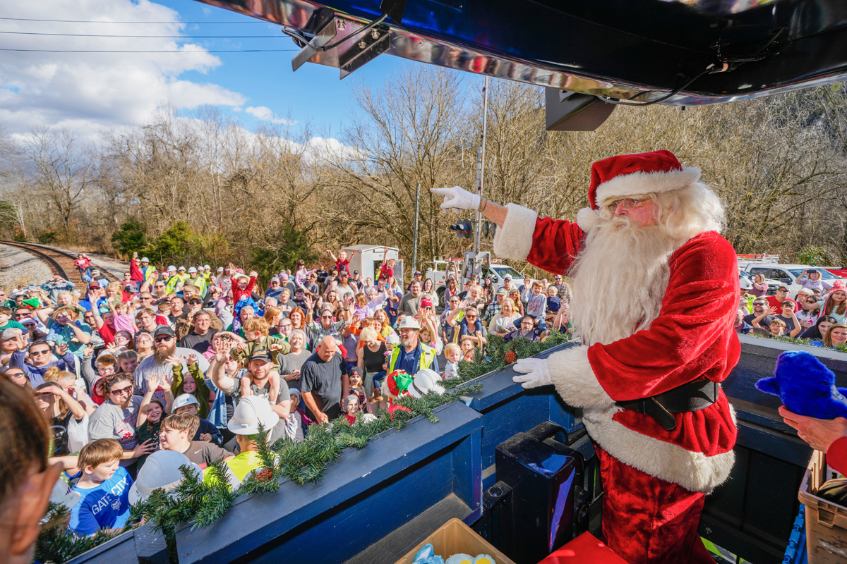 Man in Santa suit on platform of observation car