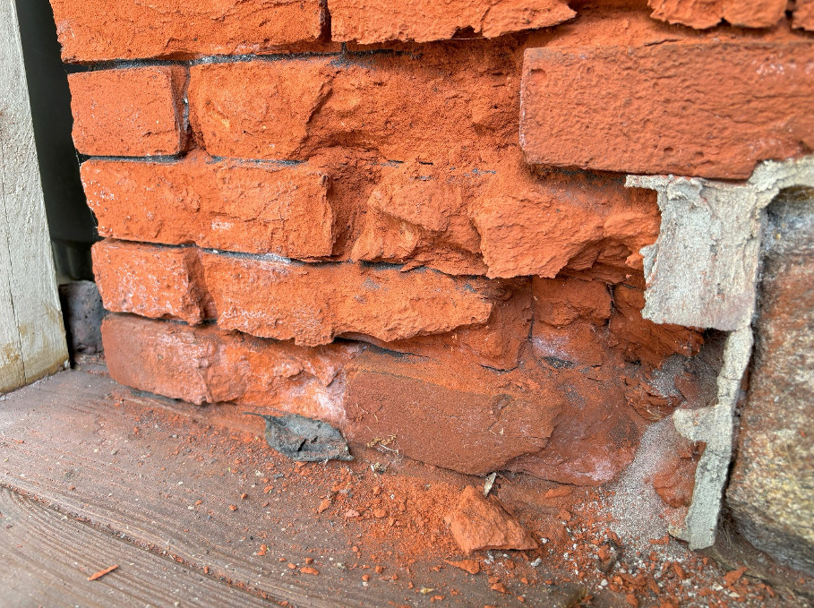 Damaged bricks on side of station building
