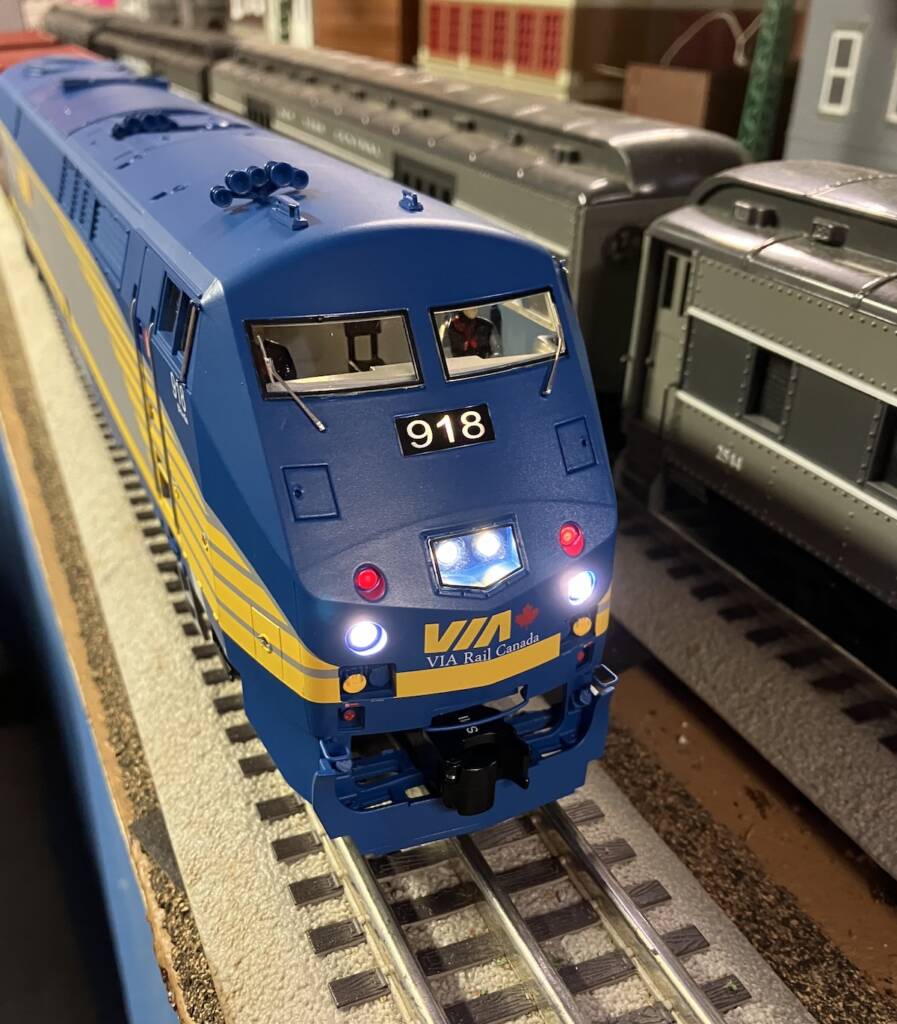 front of blue and yellow model engine with lights on