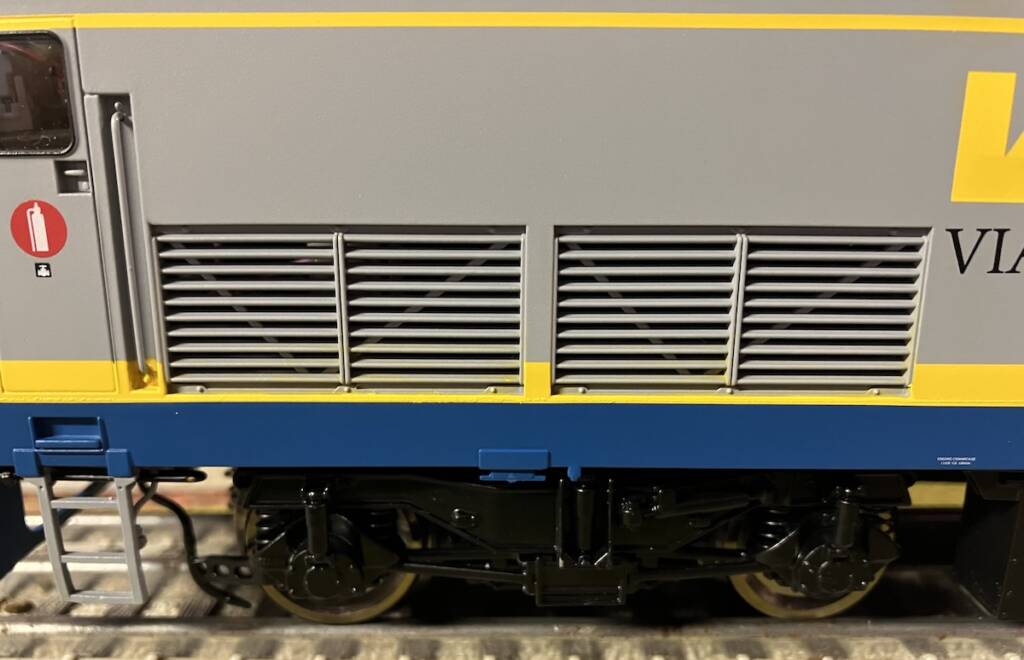 close up of yellow, silver, and blue locomotive