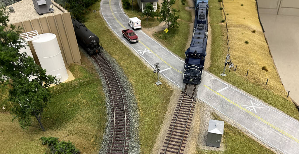 Two different colors of ballast used on a model railroad layout is viewed from overhead
