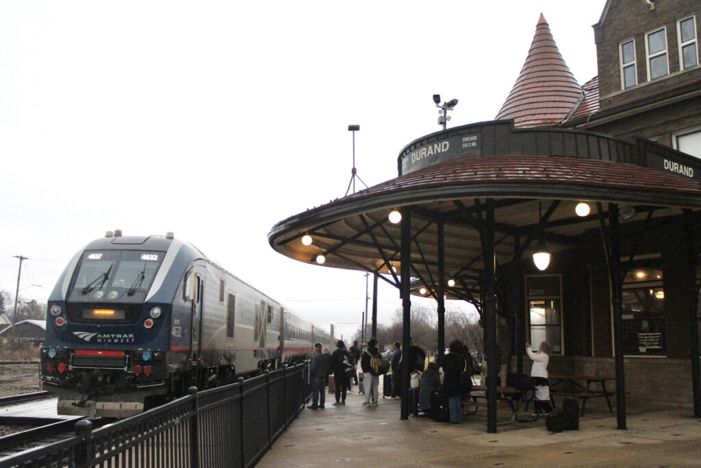 Passenger train at station with circular roof on platform