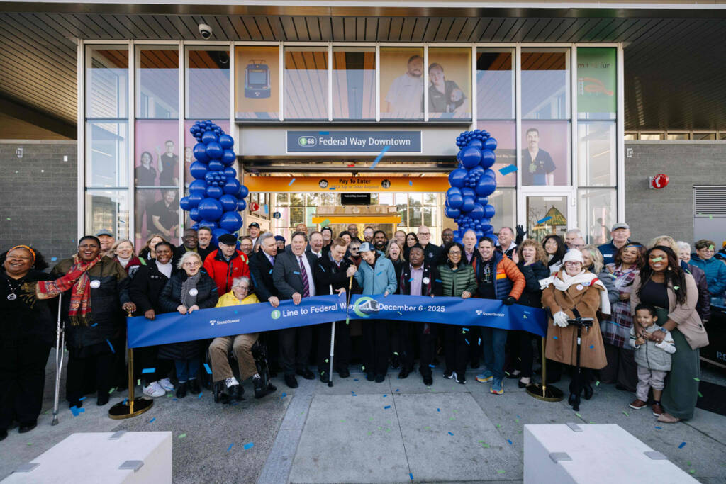 Ribbon-cutting ceremony in front of light rail station