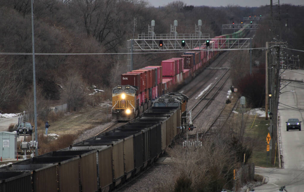 Elevated view of meet between container train and train of empty coal gondolas
