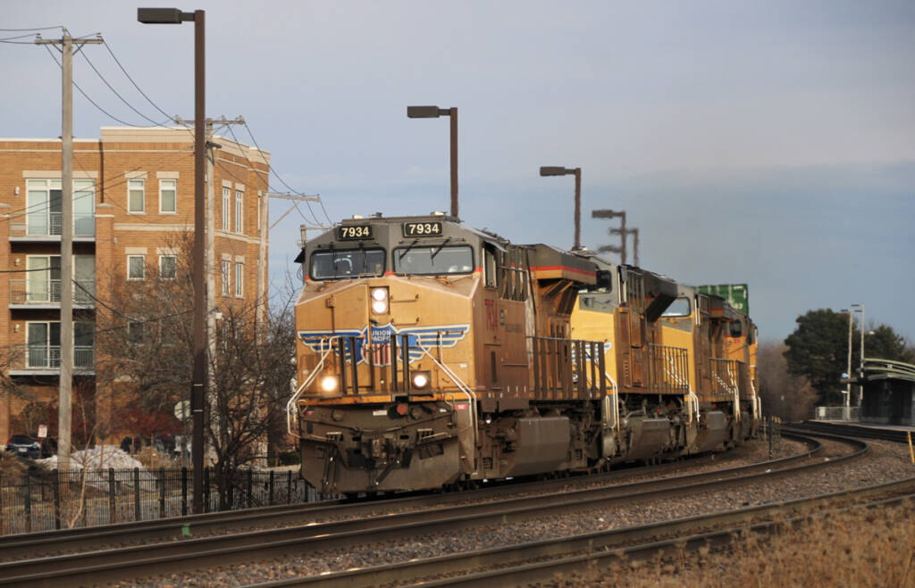 Train with five yellow locomotive rounding curve