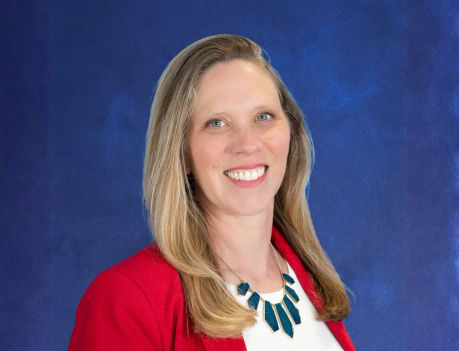 Head shot of woman in red jacket and white blouse