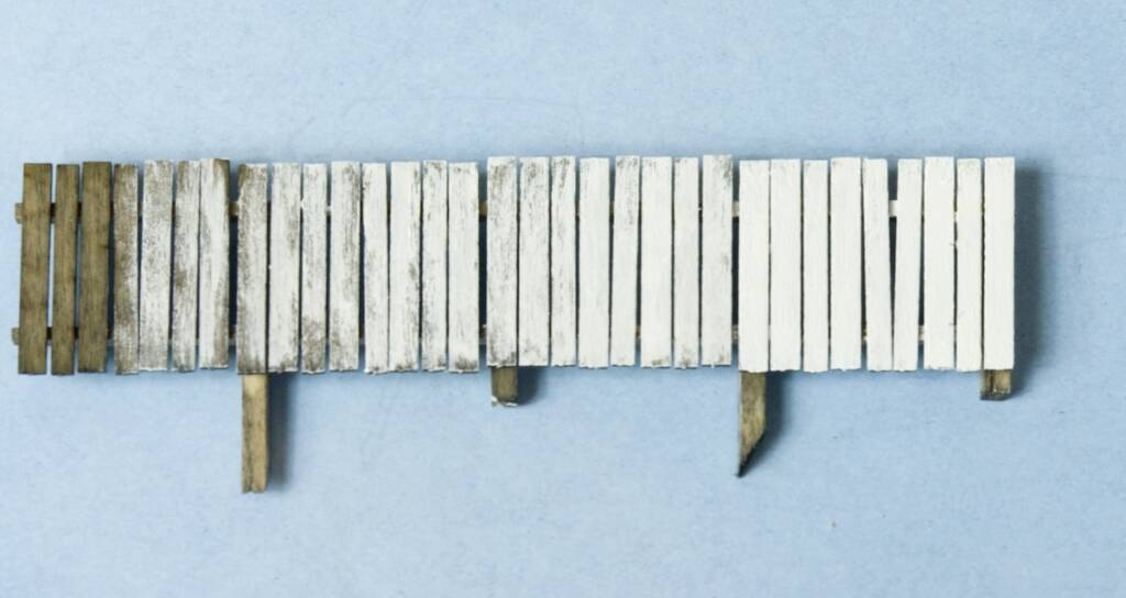 white painted model fence
