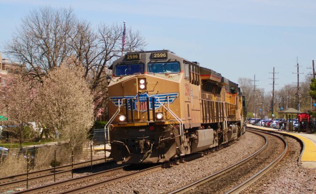Freight train with yellow locomotives on curve