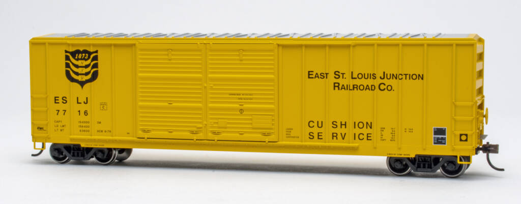 Color photo of HO scale double-door boxcar with exterior posts painted yellow with black and white graphics on white background.