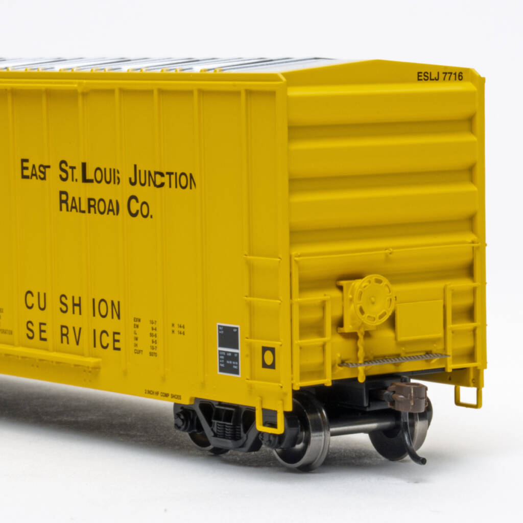 Color photo showing B end of HO scale double-door boxcar with exterior posts painted yellow with black and white graphics on white background.