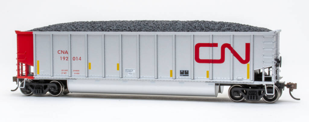 Color photo of HO scale bathtub gondola painted aluminum and red with red, yellow, black, and white graphics on white background.