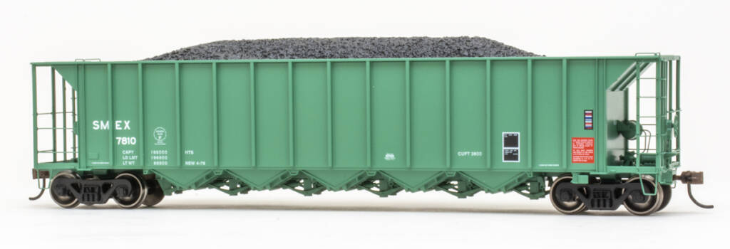 Color photo of 5-bay hopper painted light green with red, white, blue, and black graphics on white background.