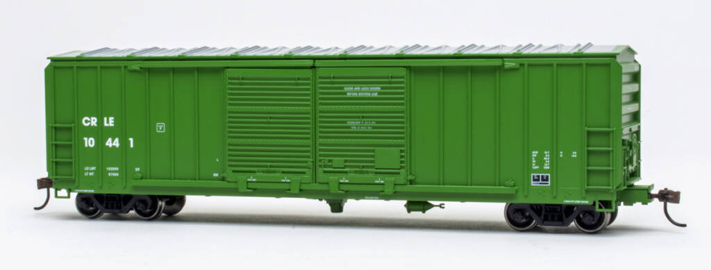 Color photo of HO scale double-door boxcar with exterior posts painted green with white and black graphics on white background. 