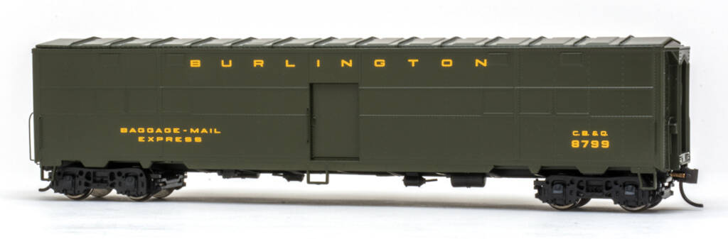 Color photo of HO scale boxcar painted dark green with gold lettering on white background.