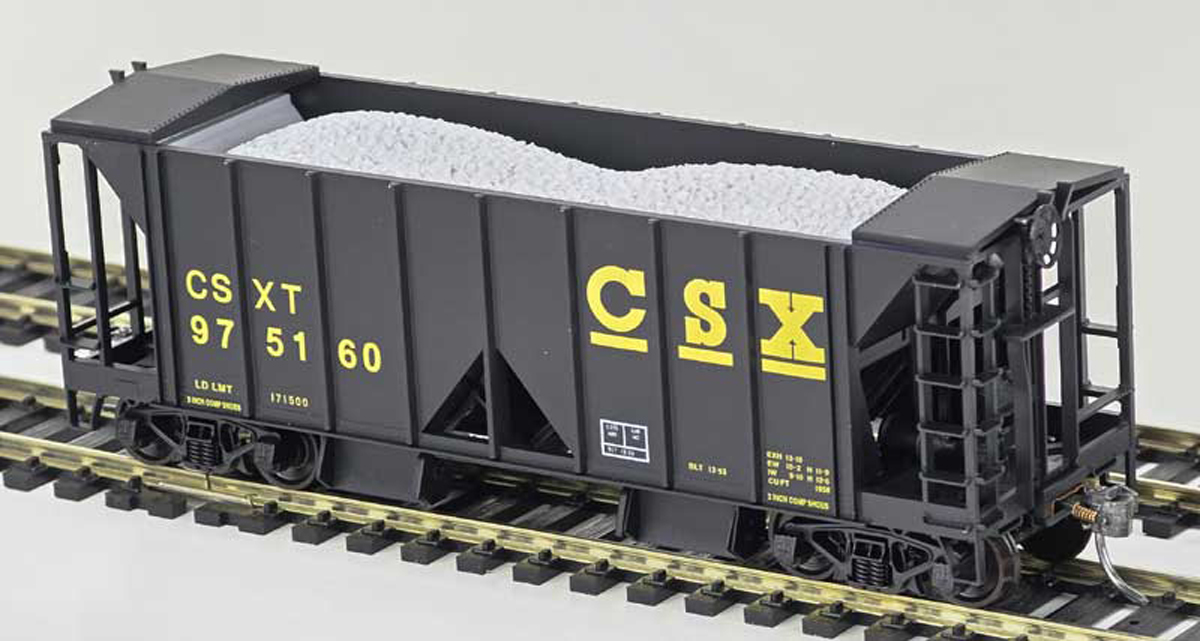 A black model ballast car with yellow lettering