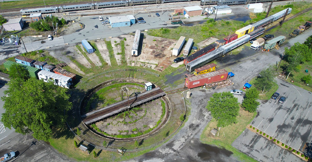Aerial view of a turntable with rail cars spotted on the radial tracks. City, TOYX discuss new turntable lease.