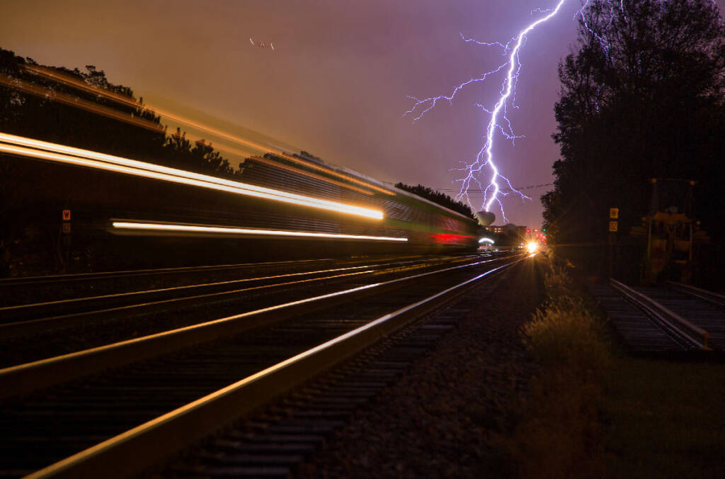 Trains Photo Contest 2026: The unexpected. Blur of train at night in a storm with lightning.
