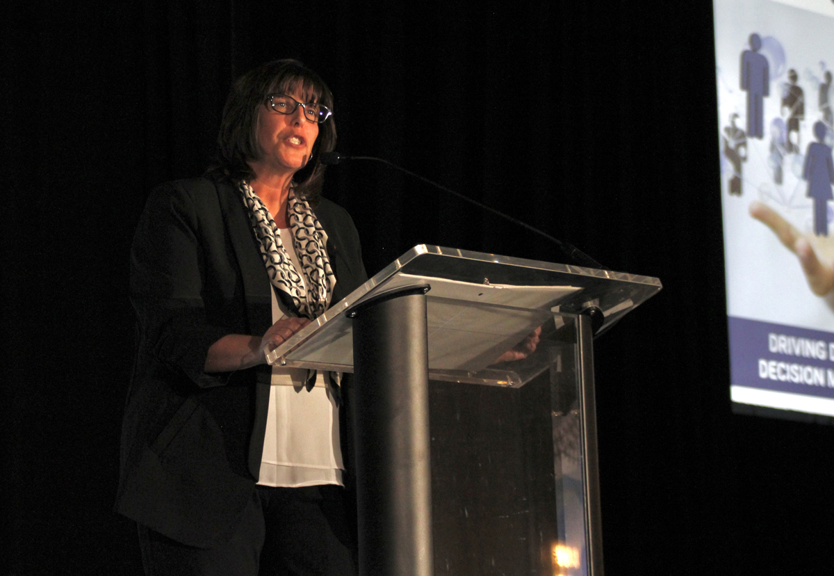 Woman speaking at podium.