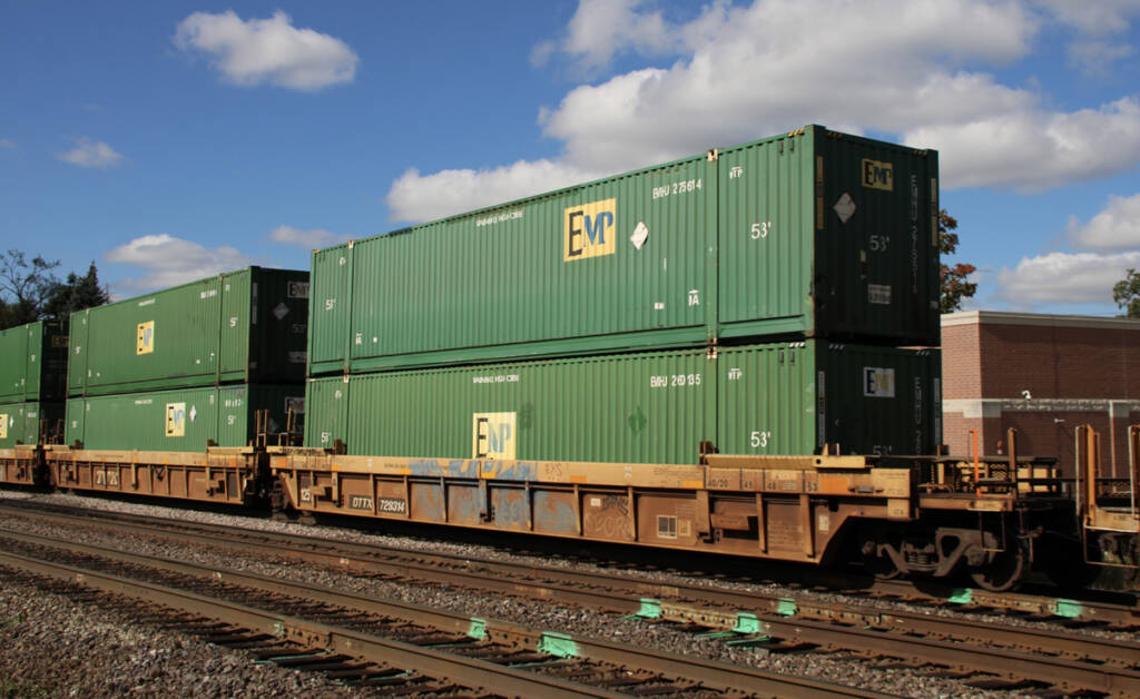 Green containers on double-stack cars