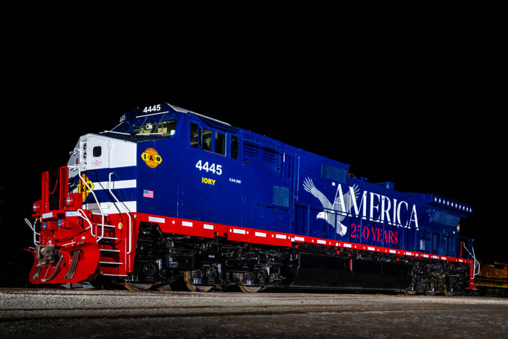 Blue locomotive with red and white trim at night