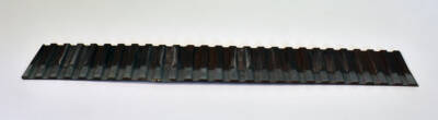 brown plastic steel bulkhead wall painted to look rusty, with white filmy appearance along the bottom edge