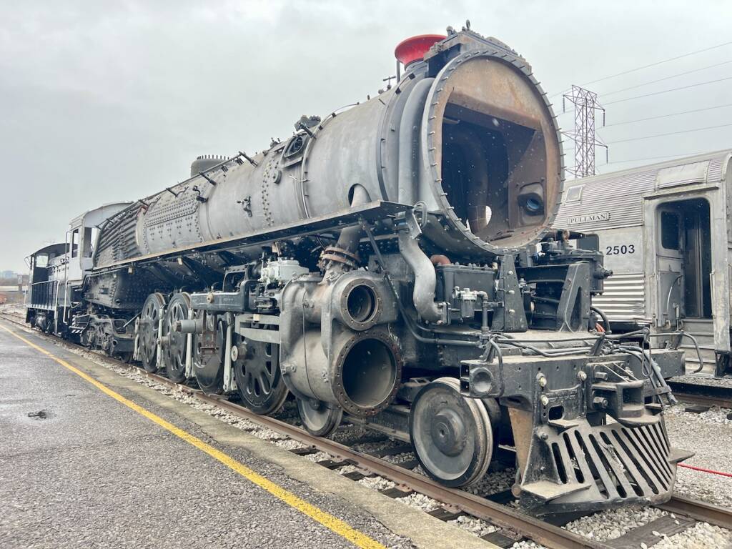 Nearly restored steam locomotive without tender sits outside