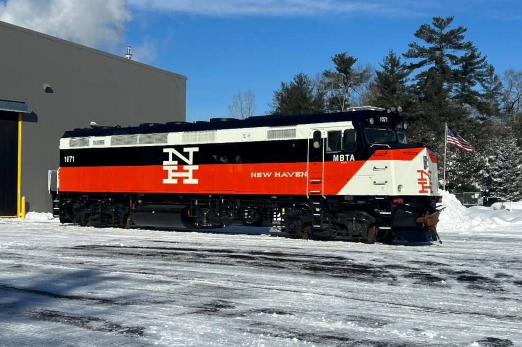 Orange, black, and white locomotive with New Haven lettering