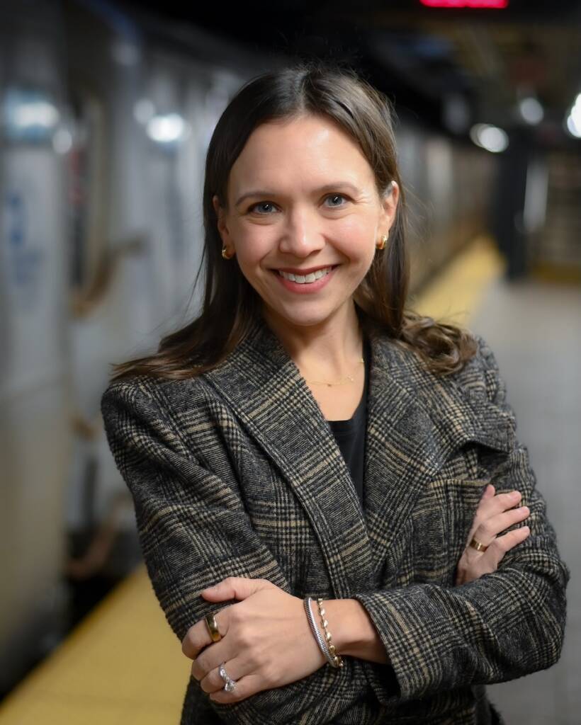 Woman posed on platform of subway station