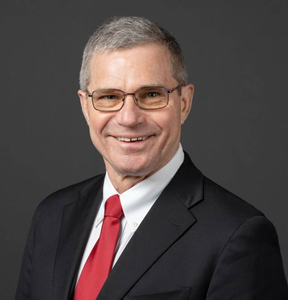 Head shot of smiling man in coat and tie