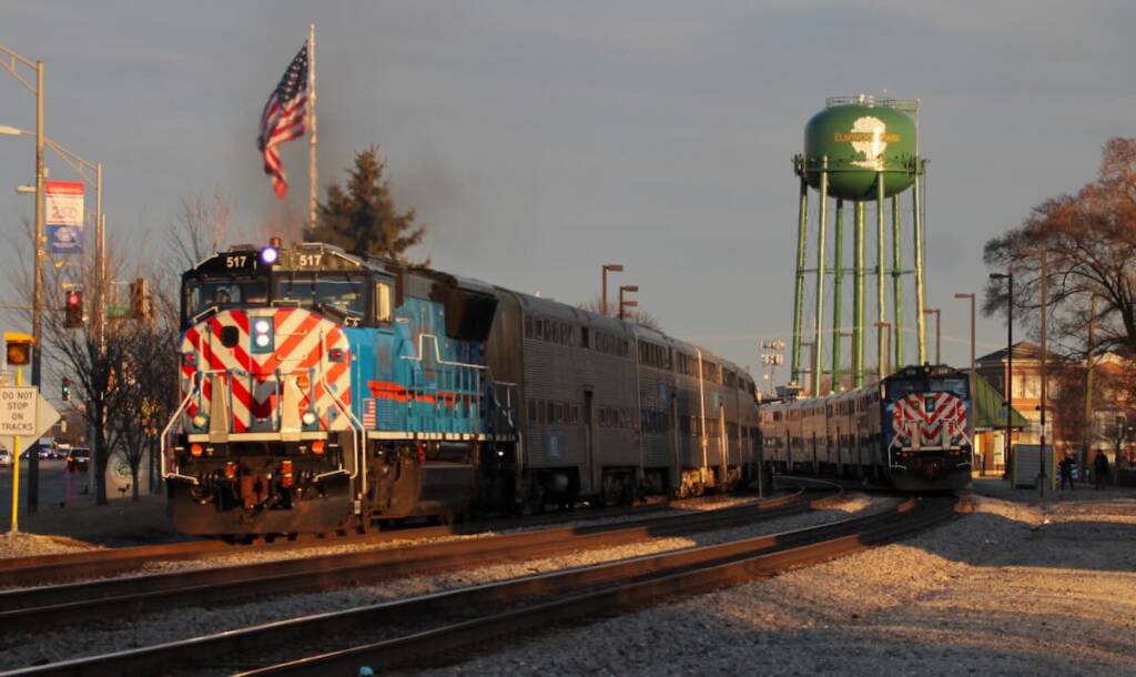 Two commuter trains meet at station on curve