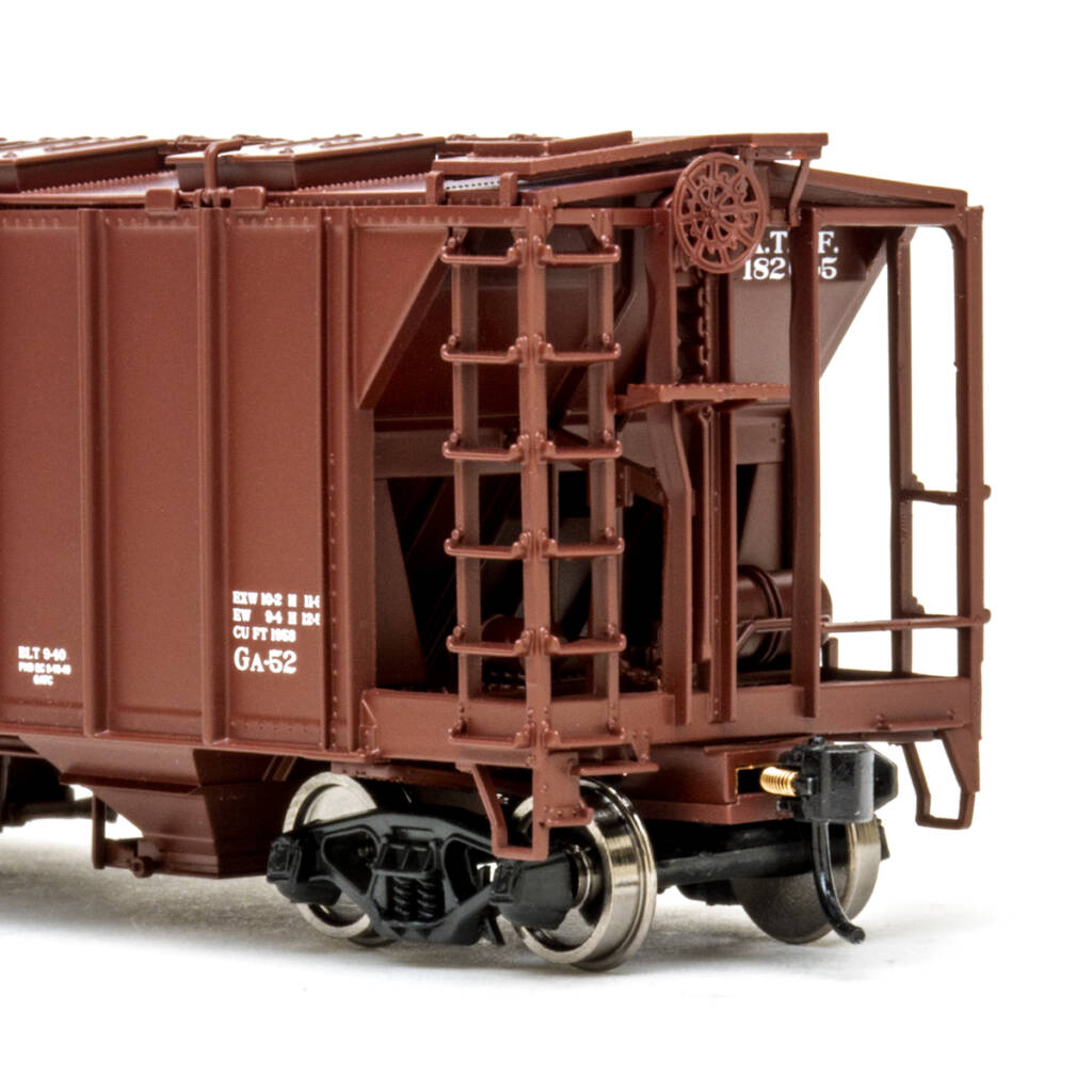 Color photo showing B end of HO scale two-bay covered hopper with exterior posts painted brown with black and white graphics on white background.