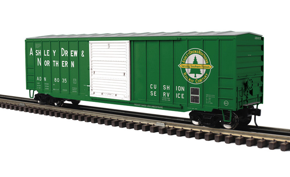 A green model boxcar with a white door