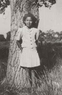 Teenage Japanese-American girl leaning against a tree. Restoring a World War II boxcar home.