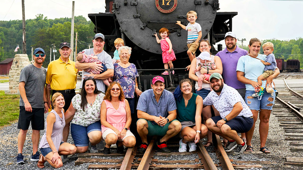 Group of people posed in front of a steam locomotive. East Broad Top Railroad announces descendants reunion June 13–14.
