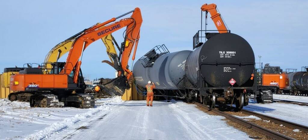 Heavy equipment moving derailed tank car