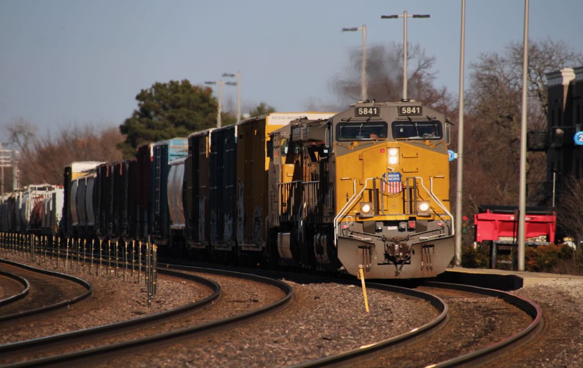 Freight train at curve on three-track main line