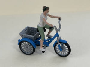 woman riding tricycle figure